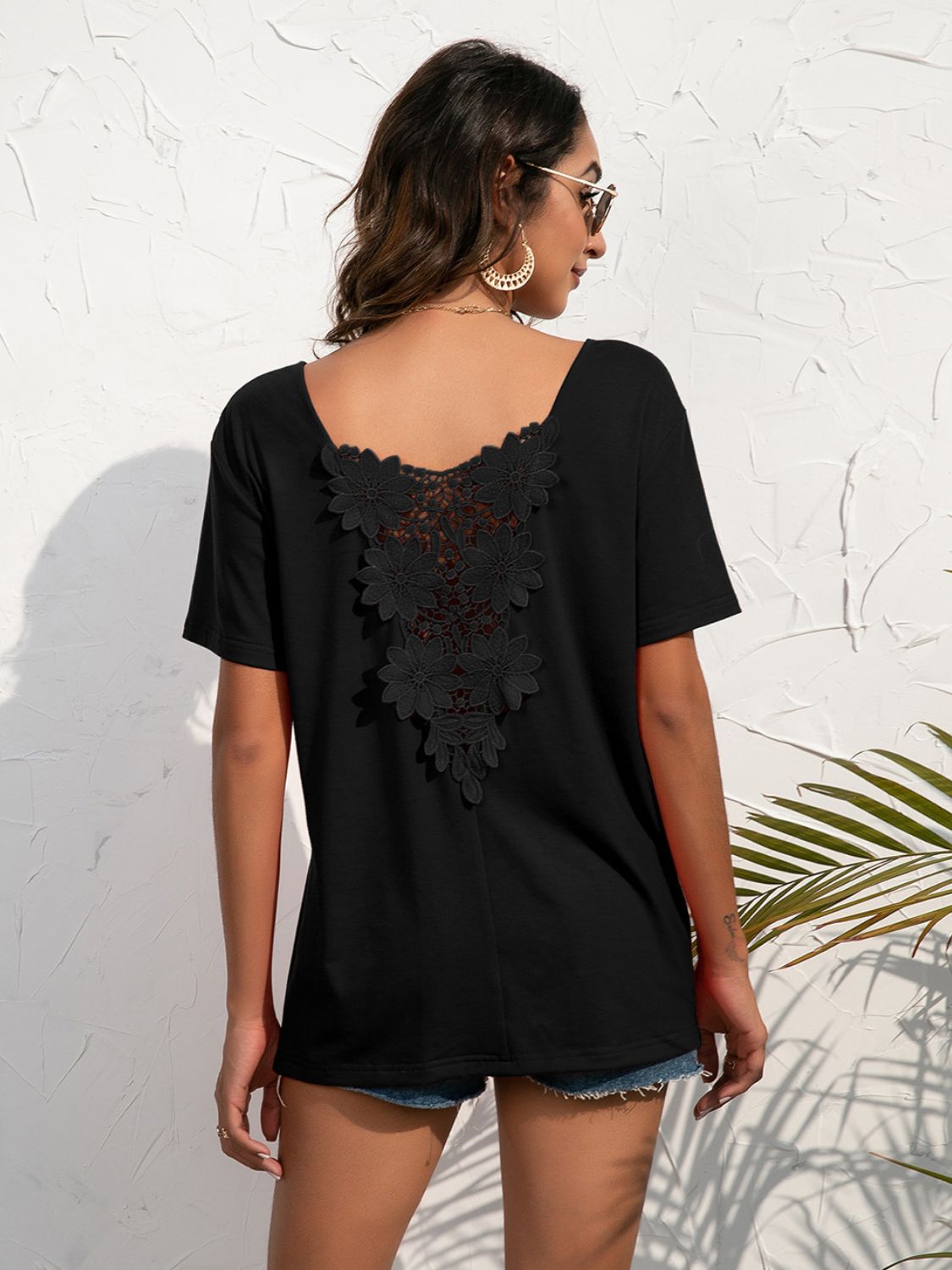 Black t-shirt with floral lace detail on the back