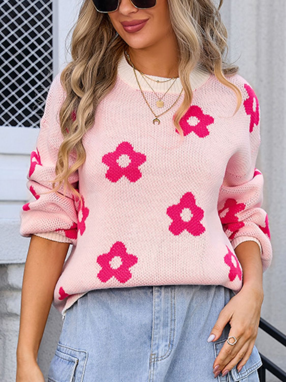 Pink knit sweater with bold hot pink flower print, crew neck, long sleeves.