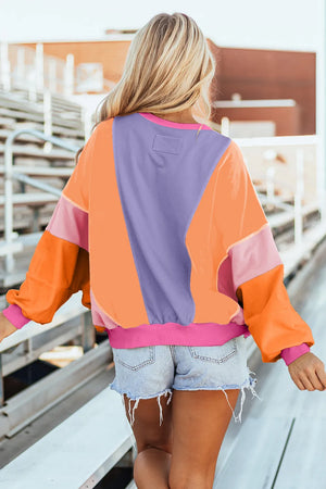 Colorblock sweatshirt with purple, tangerine, and pink panels and neon trim.