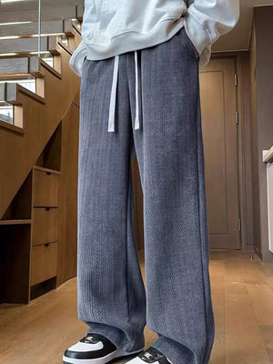 Textured wide leg sweatpants in gray with white drawstring, relaxed fit.