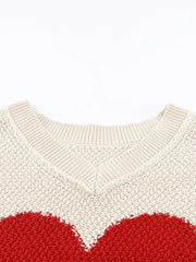 Beige v-neck knit sweater with a red heart pattern, cotton blend.