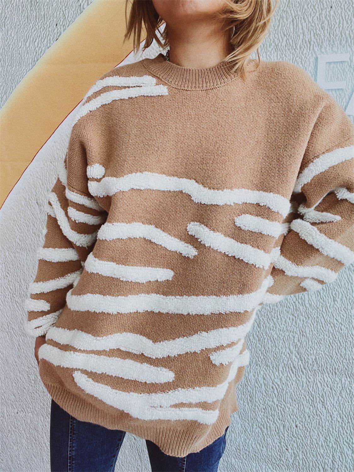 Tan acrylic crewneck sweater with textured white stripe pattern