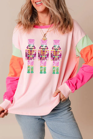 Colorblock long sleeve tee in blush pink with nutcracker graphic and contrast sleeves.