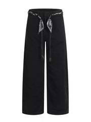 Black maternity pants with wide legs and a patterned belt with beaded ties.