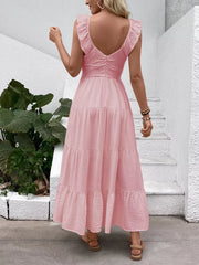 Blush pink tiered maxi dress with flutter sleeves and V-neck, back view.
