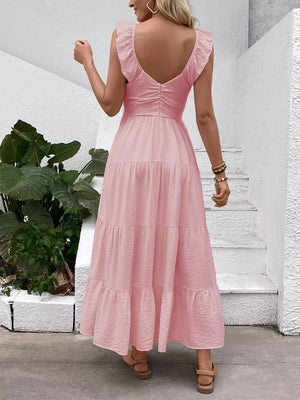 Blush pink tiered maxi dress with flutter sleeves and V-neck, back view.
