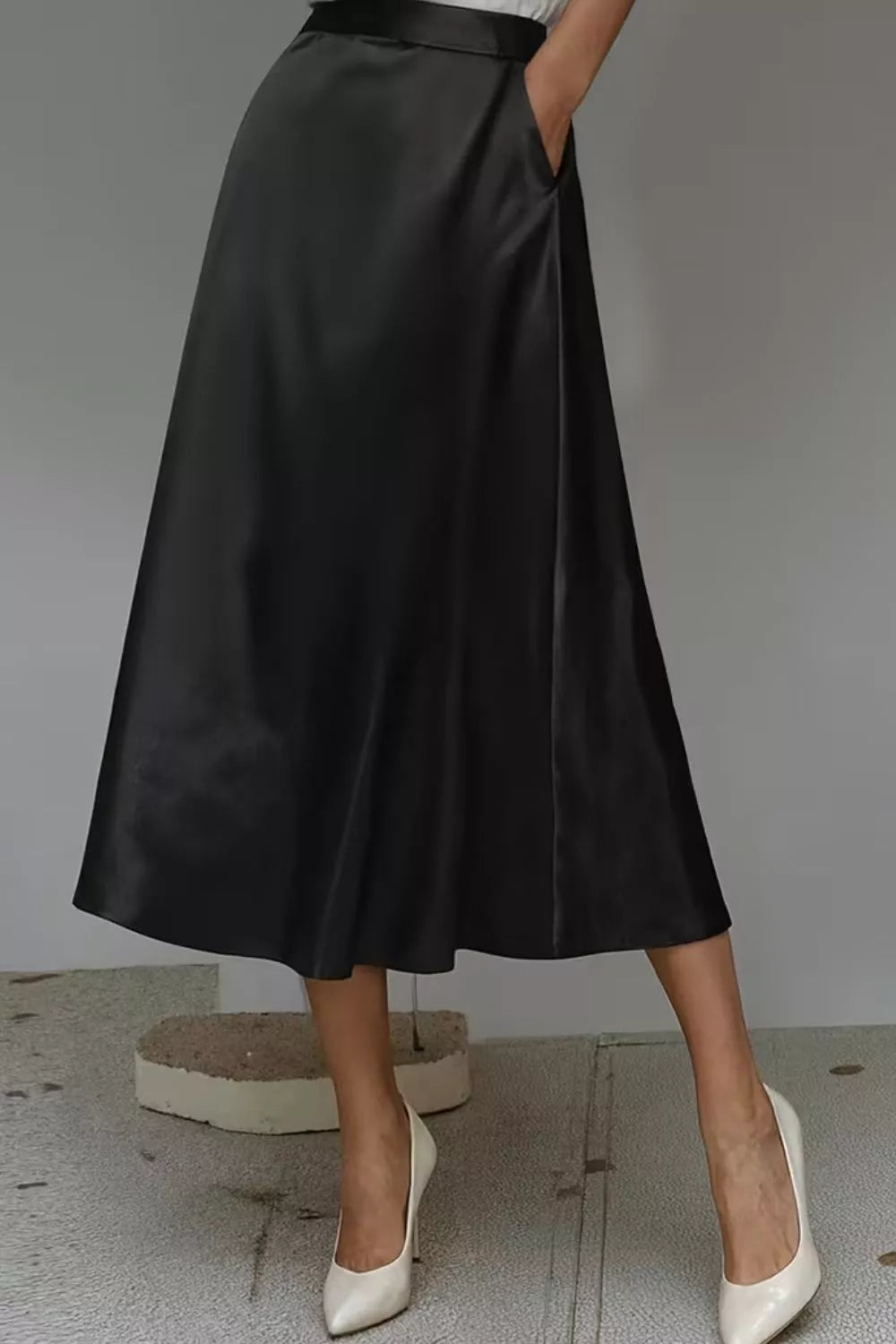 Black a-line midi skirt with hidden pockets in lustrous fabric