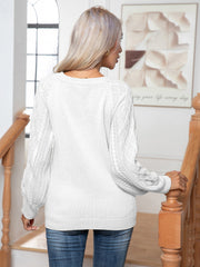 White cable knit henley sweater with button detail on a woman wearing jeans.