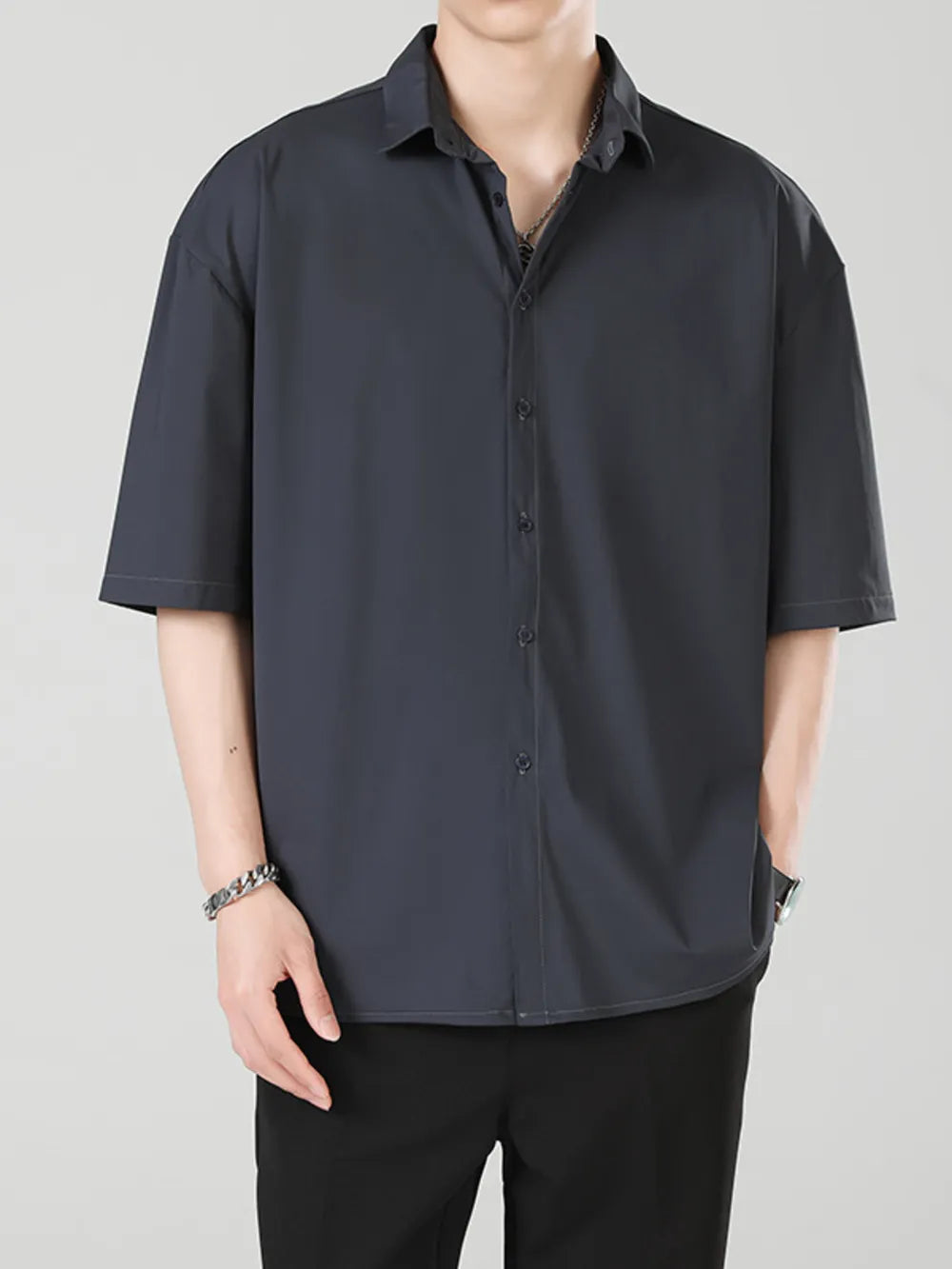 Men's oversized dark gray short sleeve button-up shirt with a collared neckline.