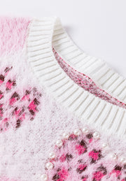 Fuzzy blush pink knit sweater with heart jacquard pattern and pearl embellishments.