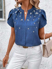 Blue embroidered floral keyhole blouse with short flutter sleeves.