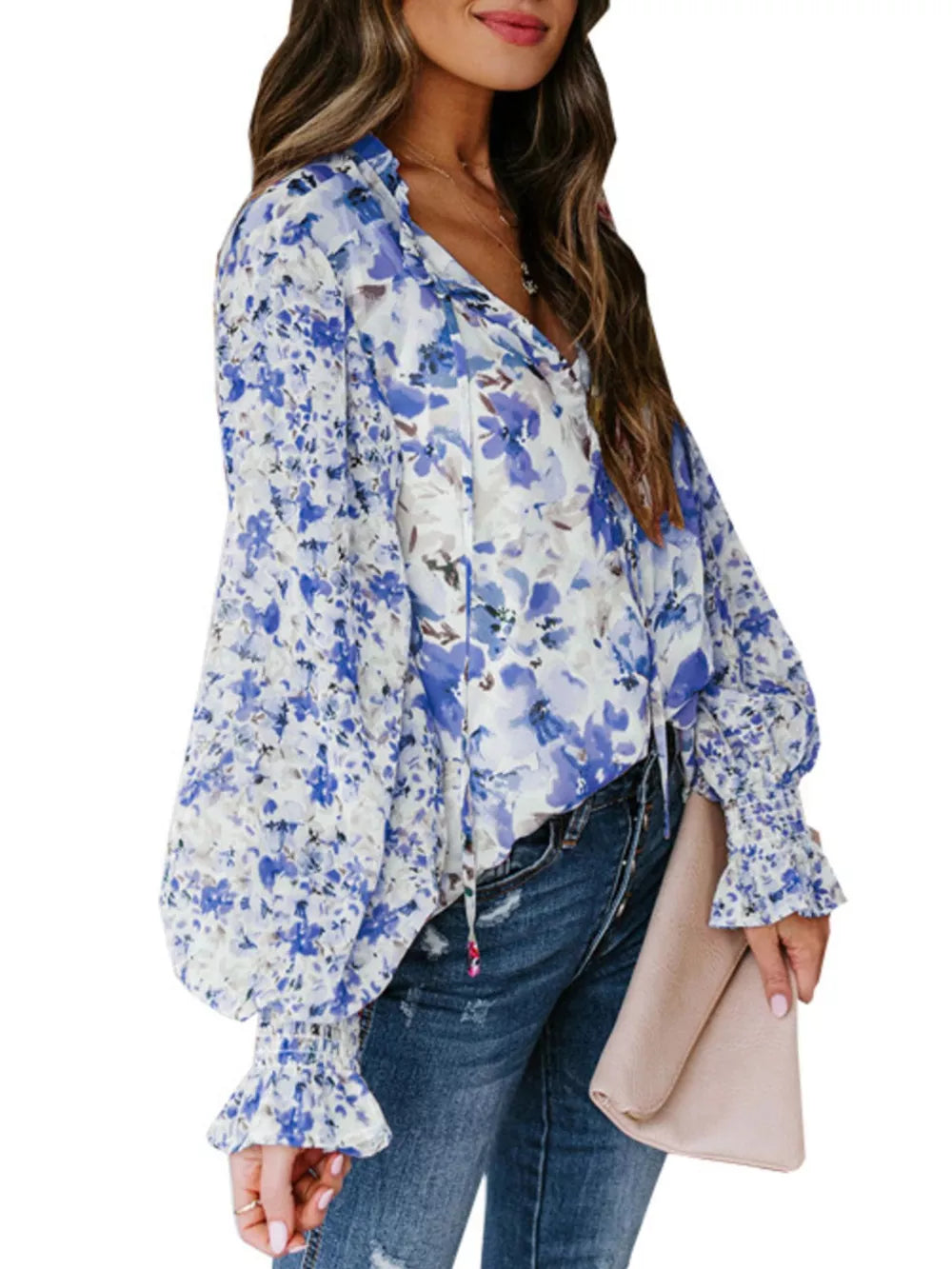 Blue floral print tie-detail blouse with long balloon sleeves and ruffled cuffs.
