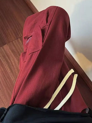 Burgundy relaxed fit cargo sweatpants with drawstring and zippered pocket detail.