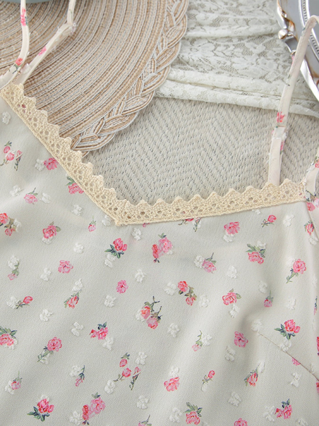 Floral cami with lace trim and delicate pink floral print.