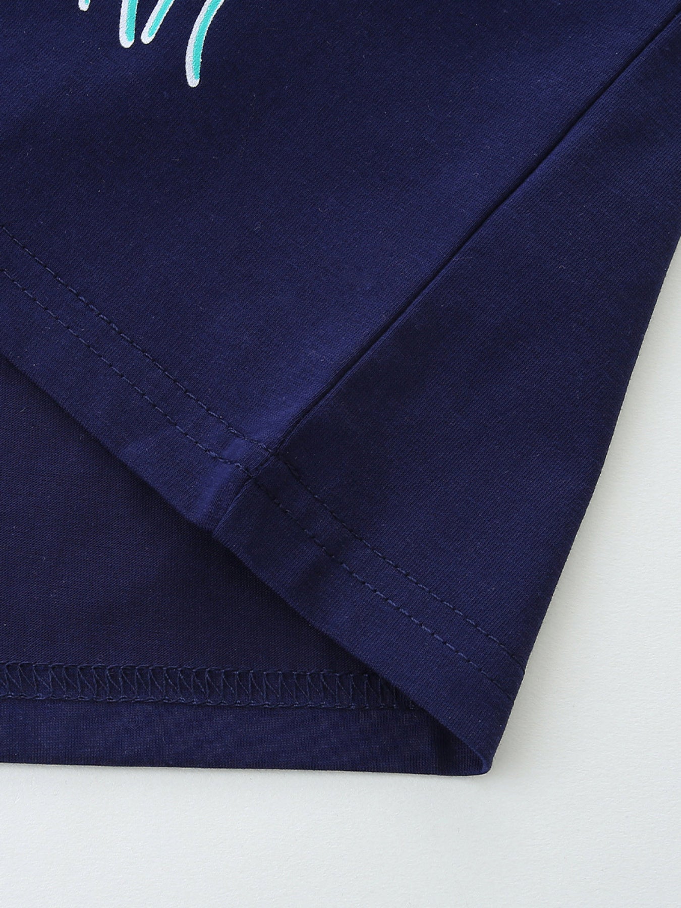 Navy cotton t-shirt with double-stitched hem and side seam detail.