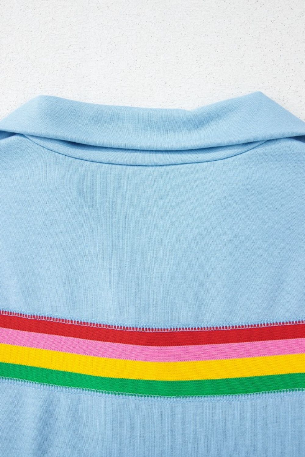 Light blue activewear shorts with rainbow stripe detail and collar