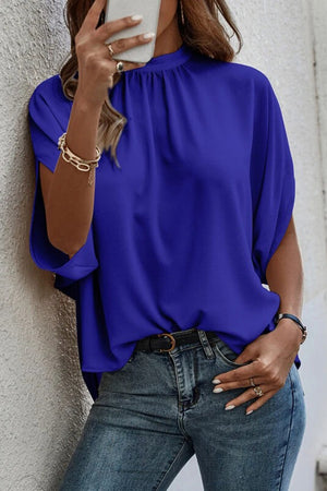 Royal blue blouse with draped sleeves and a high neckline with a keyhole back detail.