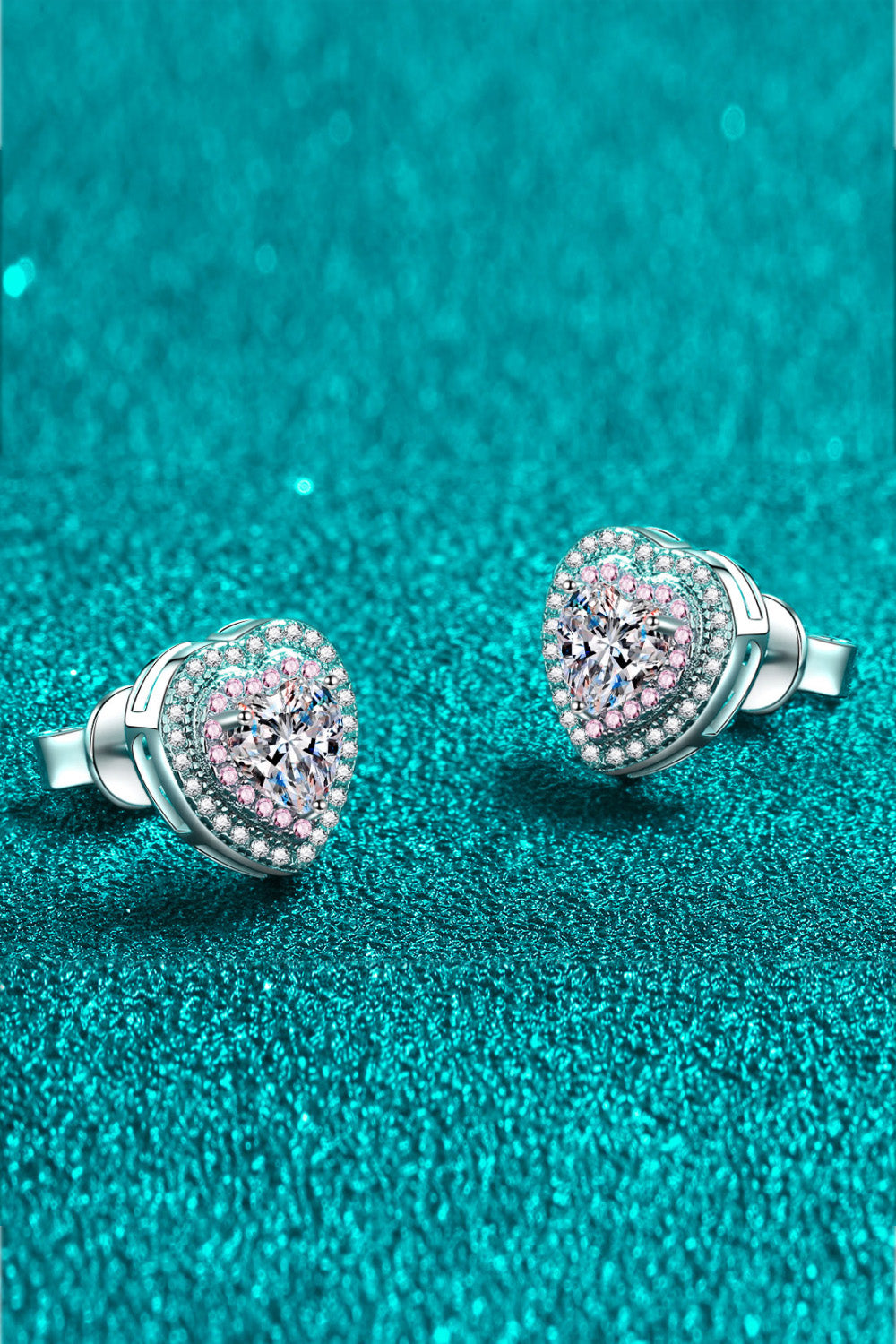 Silver heart halo stud earrings with pink accents and clear center stone