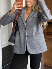 Chic gray lapel blazer with button closure and practical pockets, styled casually.