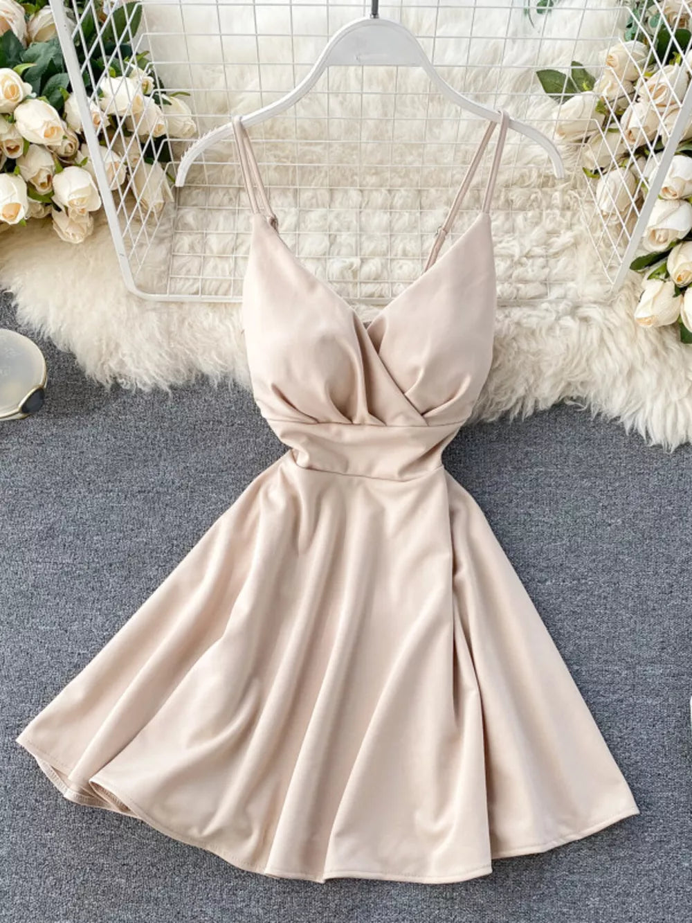 Apricot V-neck spaghetti strap mini dress with adjustable straps and a flared skirt.