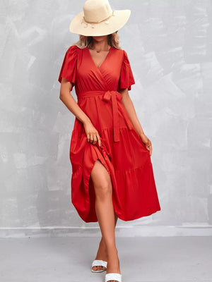 Orange-red flutter sleeve tiered midi dress with a belted waist and V-neck.