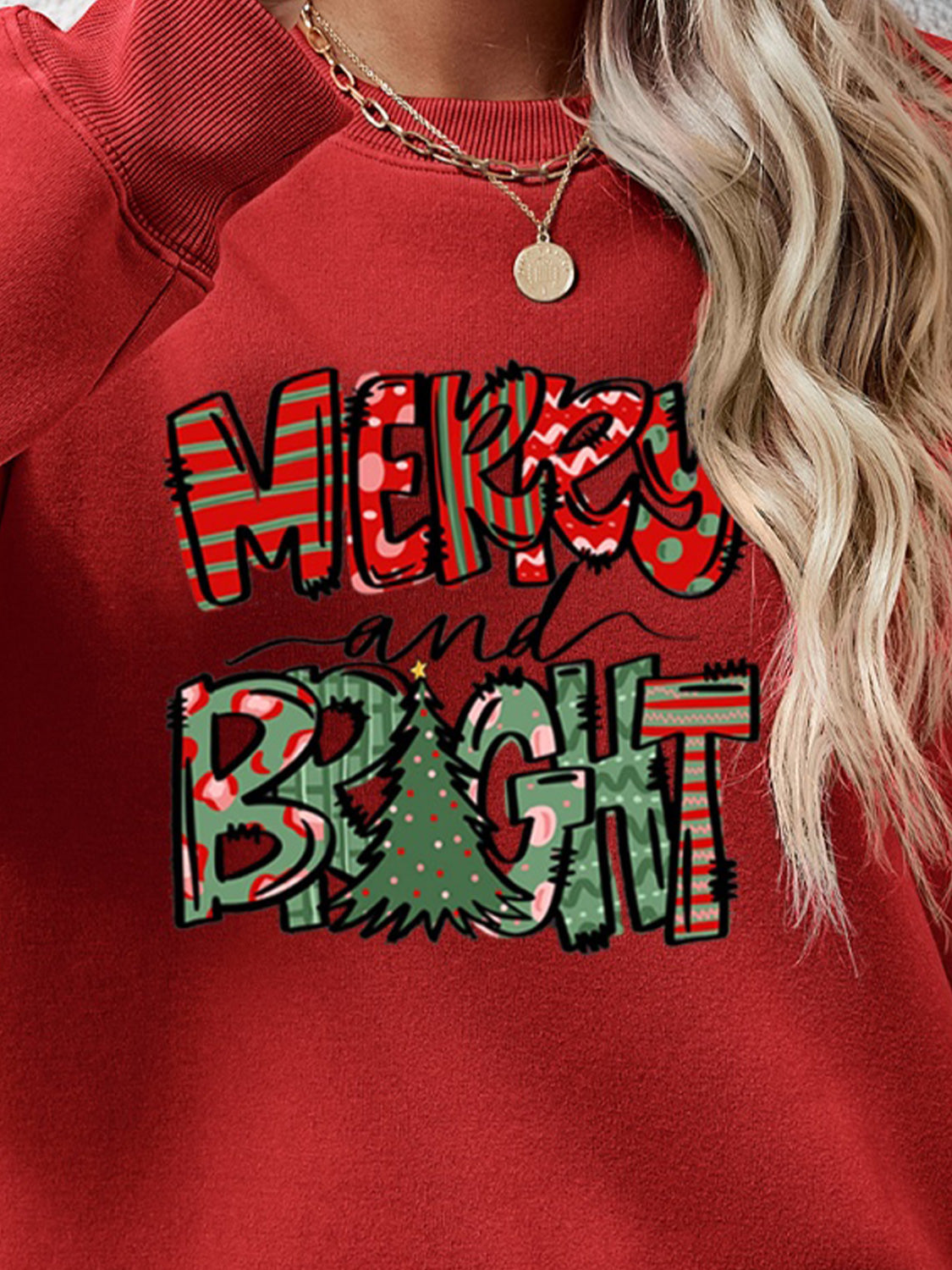 Crewneck sweatshirt in Deep Red with Merry and Bright graphic and Christmas tree detail.