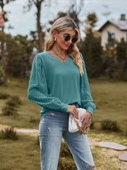 Teal Swiss dot sleeve v-neck blouse with long puff sleeves.