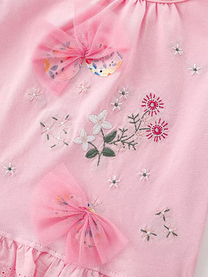 Pink cotton t-shirt with embroidered floral details and pink tulle bows.