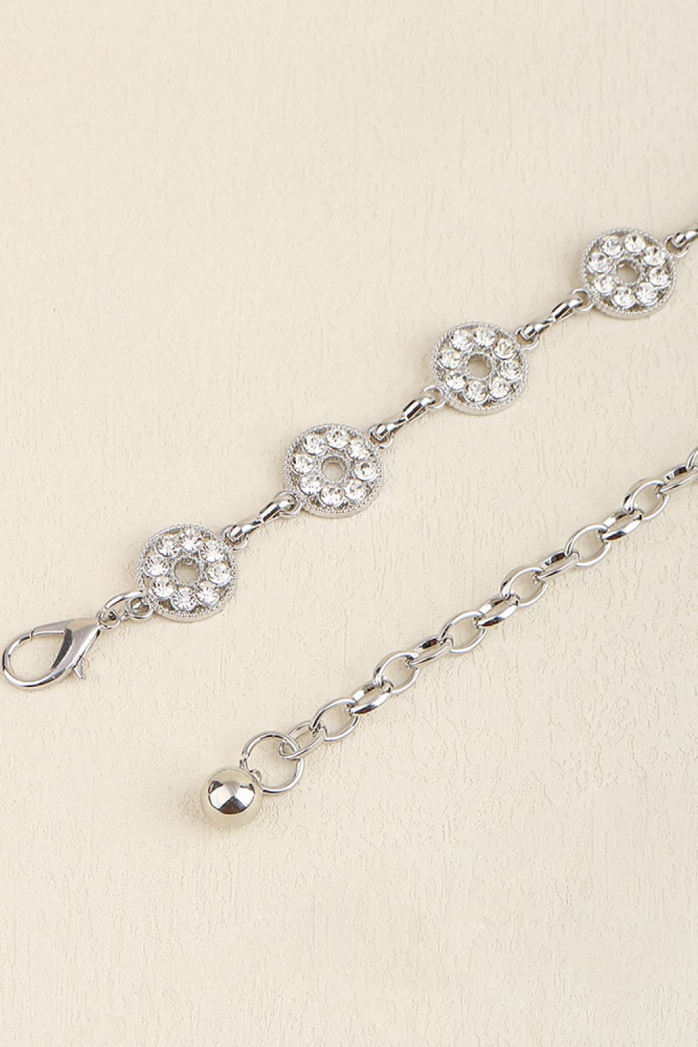 Silver chainmail belt with circular rhinestone accents and a lobster clasp closure.