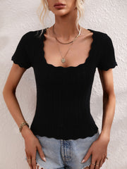 Black knit top with scalloped square neckline and short sleeves.
