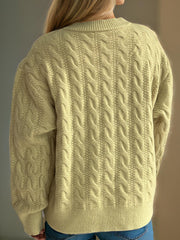 Pastel Yellow cable knit cardigan with puff sleeves and crew neck.