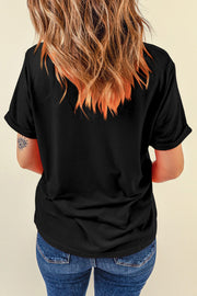 Black graphic tee with rolled sleeves and a round neckline.