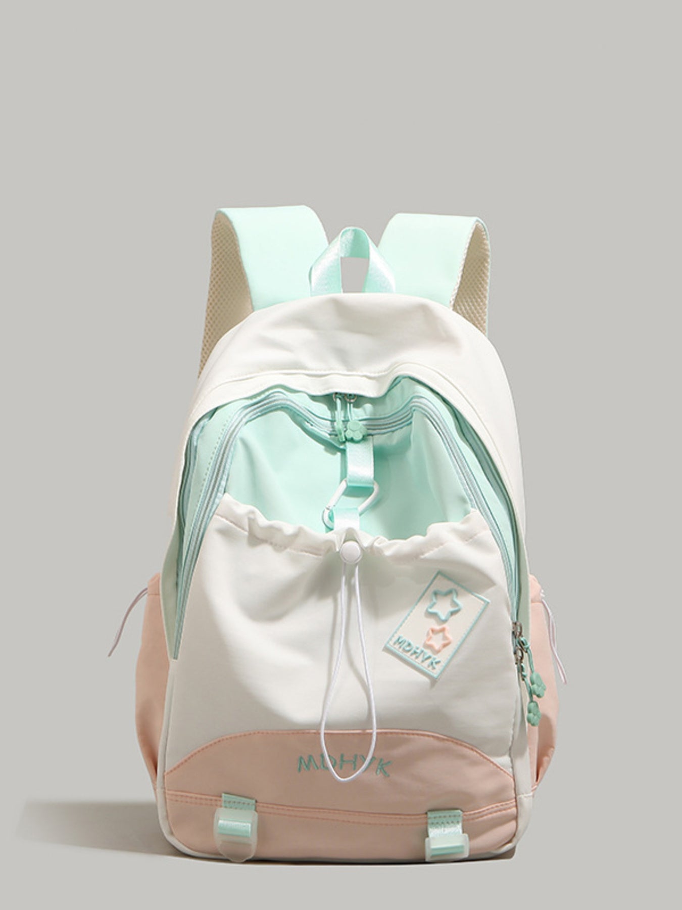 Nylon drawstring backpack with pockets in colorblock white, mint green, and peach with star patch detail.