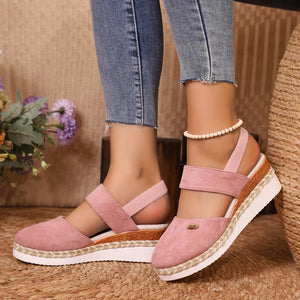 Dusty pink espadrille wedge slingback sandals with braided jute detail and elastic straps.