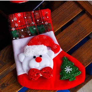 Festive Santa face stocking with plaid cuff, red glitter bow, and green glitter tree.