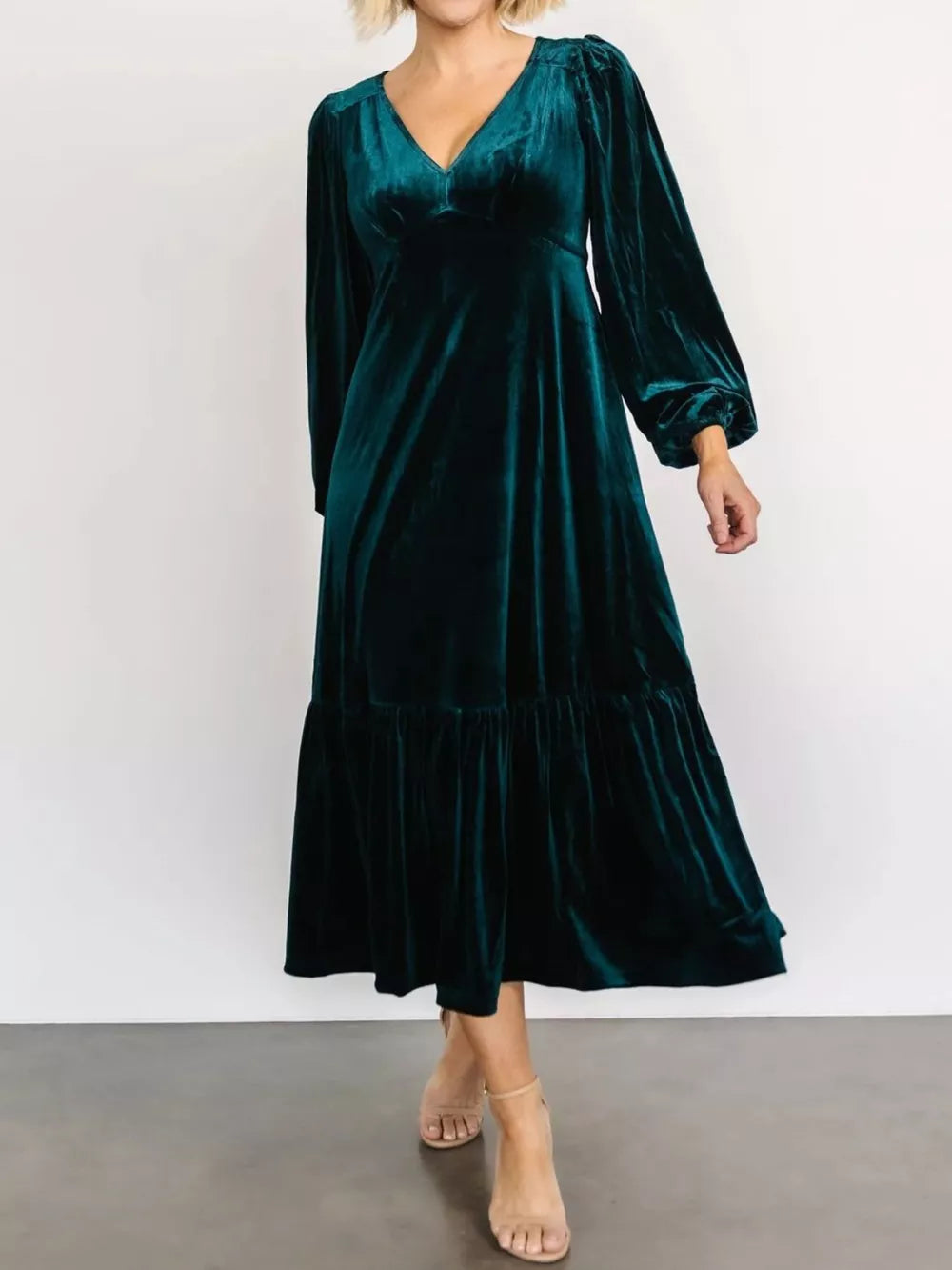Peacock blue velvet midi dress with tiered skirt and bishop sleeves.