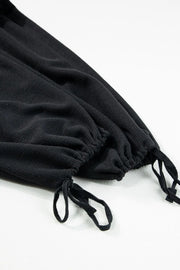 Black waffle knit jumpsuit with drawstring ankles