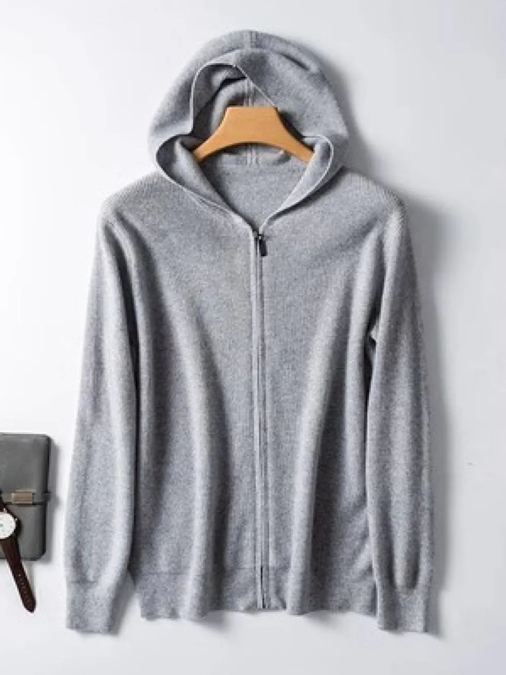 Gray cashmere hooded zip-up sweater with a full zipper closure.