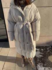 Chic padded trench coat in ivory white with tie-belt and hood.