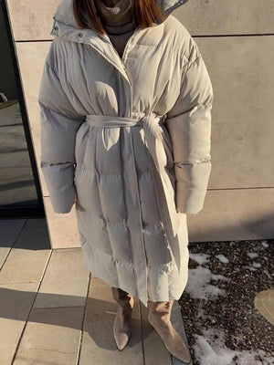 Chic padded trench coat in ivory white with tie-belt and hood.