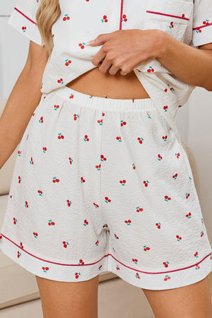 White textured pajama shorts with cherry print and contrast piping