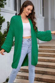 Mid green textured knit cocoon cardigan with balloon sleeves and open front.