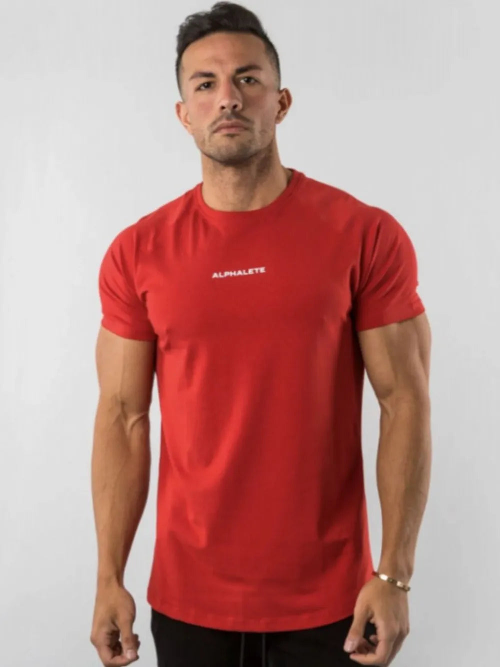 Red crew neck athletic t-shirt with small white logo detail on chest