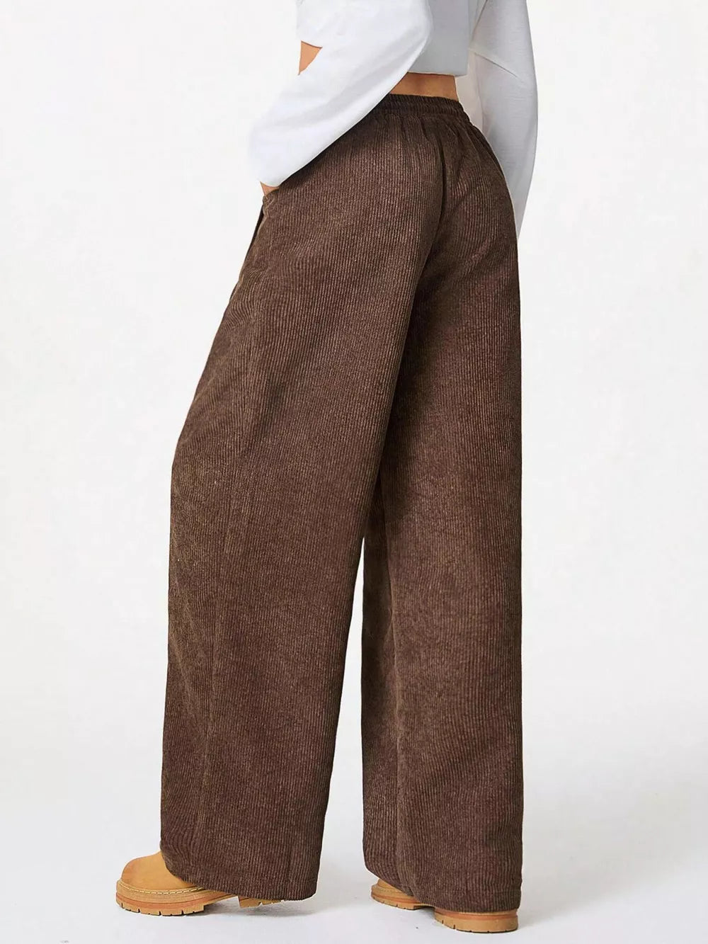 Brown corduroy maternity trousers with a wide-leg cut and elastic waistband.