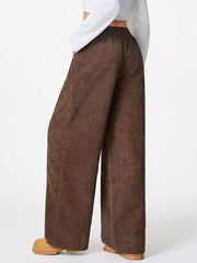 Brown corduroy maternity trousers with a wide-leg cut and elastic waistband.