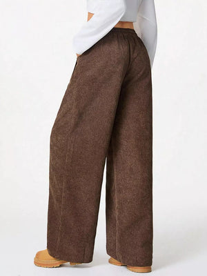 Brown corduroy maternity trousers with a wide-leg cut and elastic waistband.