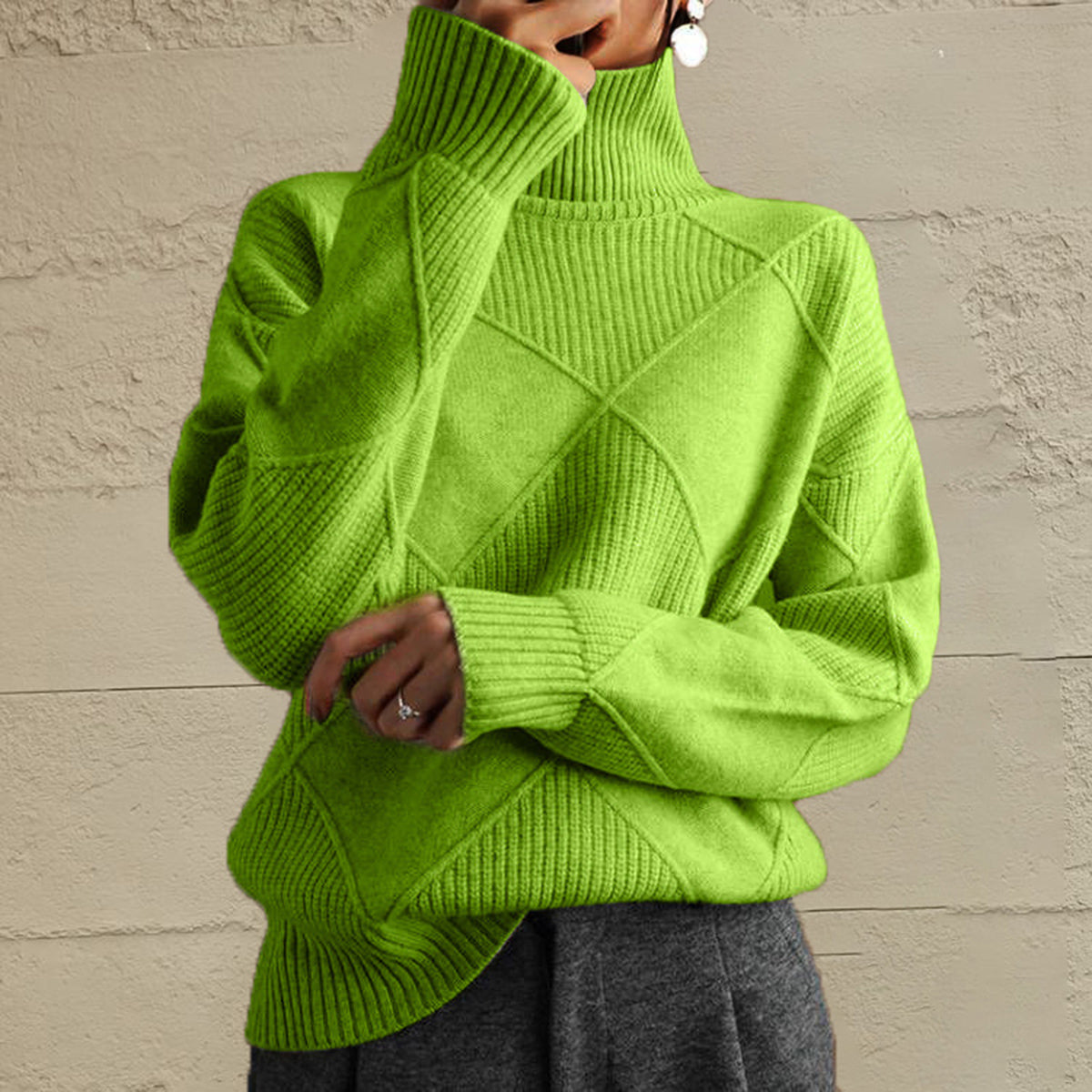 Textured diamond knit turtleneck pullover sweater in yellow-green with ribbed cuffs and hem.