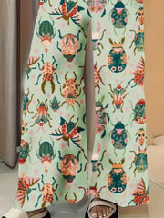 Pastel yellow wide-leg maternity trousers with a colorful beetle print.