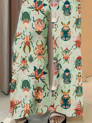 Pastel yellow wide-leg maternity trousers with a colorful beetle print.