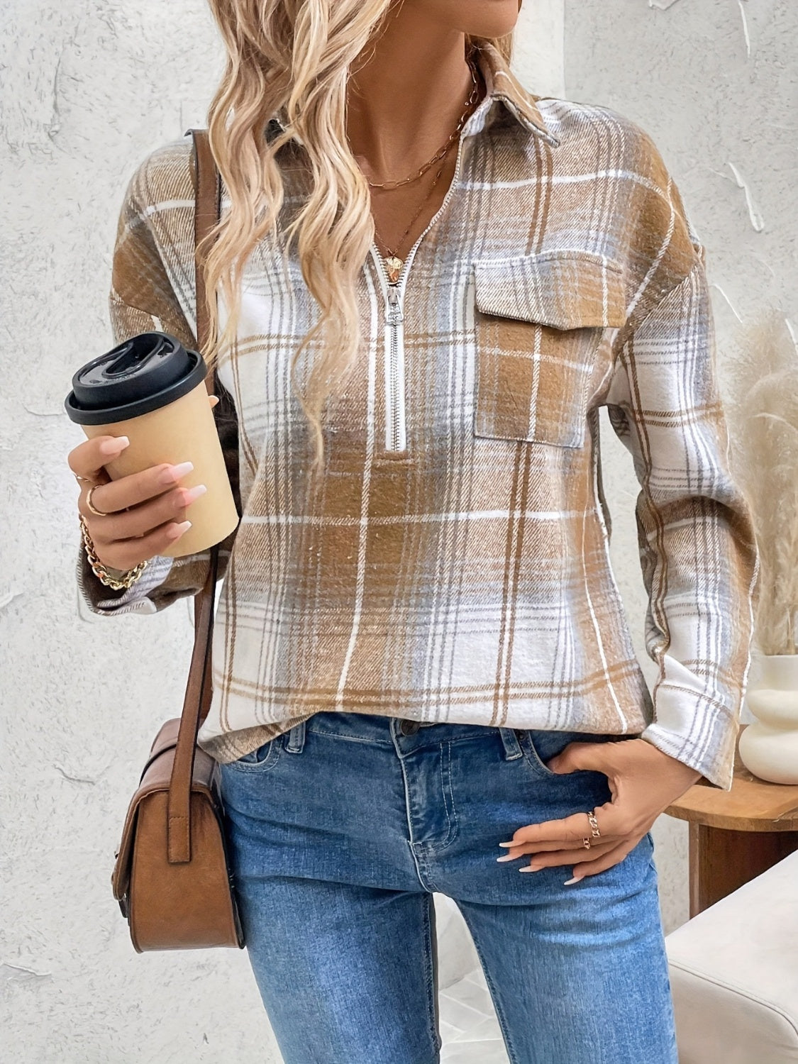 Plaid zip-through utility blouse in camel with a chest pocket and collared neckline.